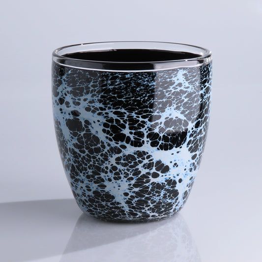 A glossy black glass planter with a white and light blue marble or crackle pattern, set against a clean light gray background.