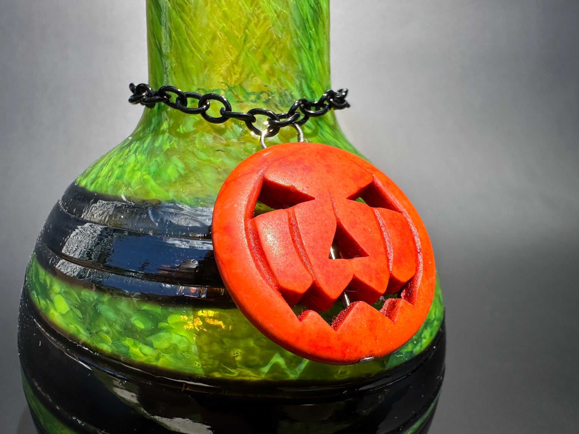 alt="Green&Black Potions Bottle w/pumpkin close up"