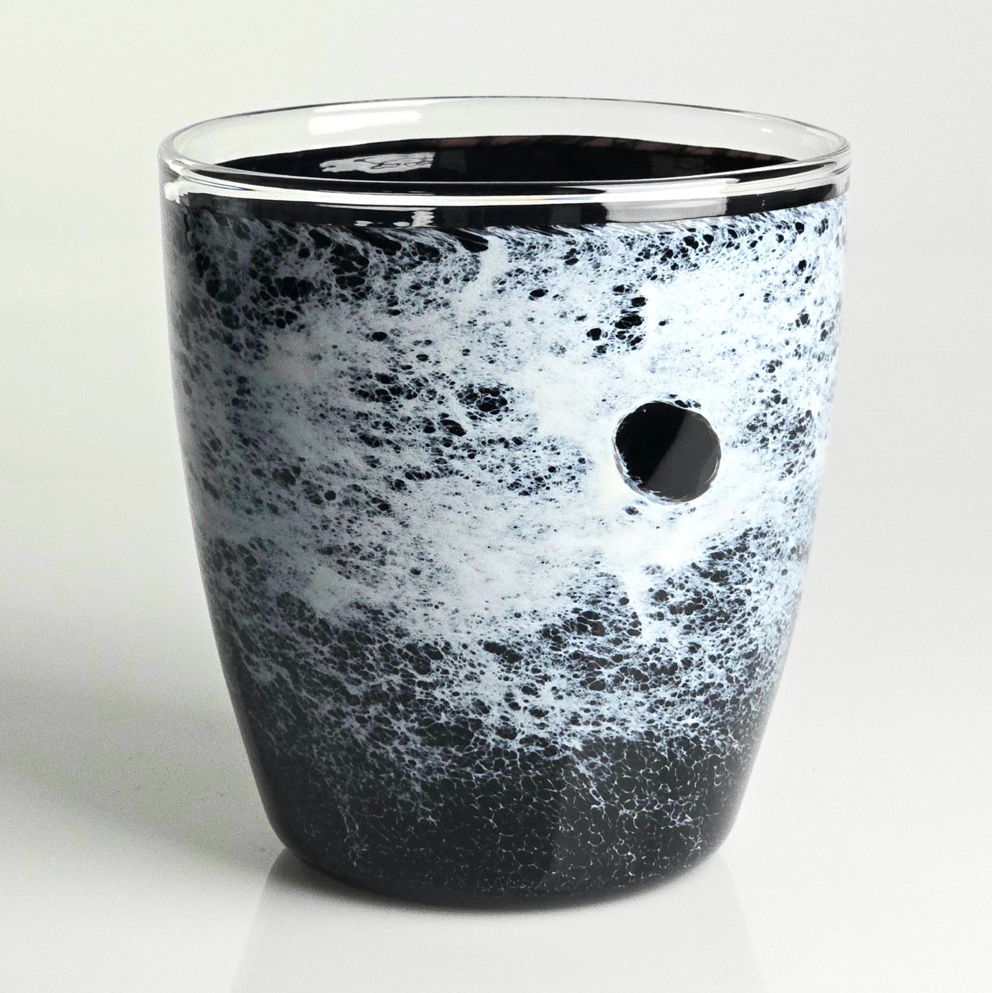 A black and white speckled glass planter with a small circular hole on the side, set against a clean white background.