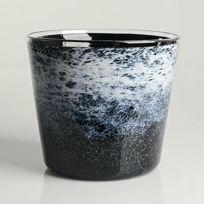 A glass planter with a black and white marbled, speckled pattern, featuring a polished clear rim, set against a light gray background.