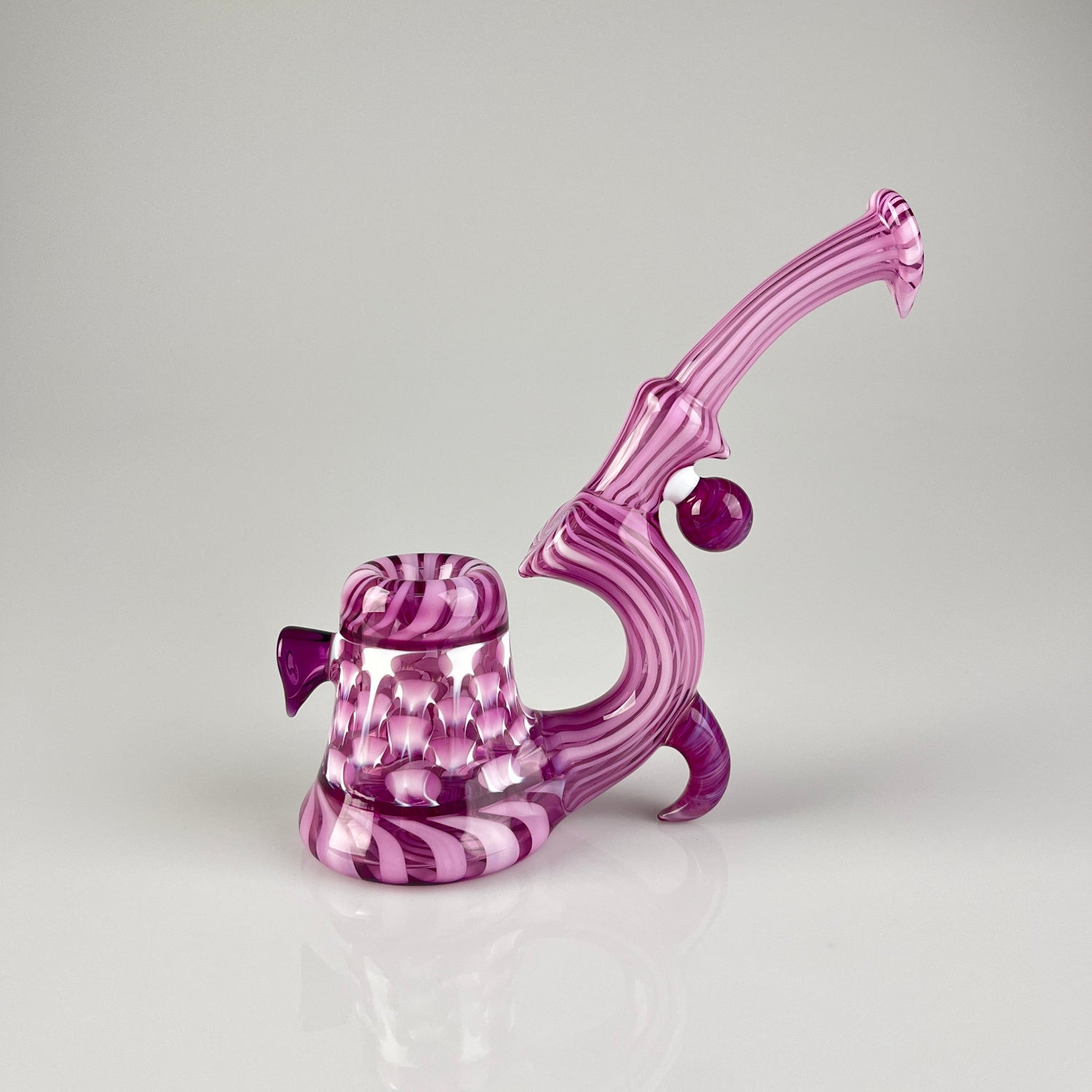 A purple and magenta striped glass smoking pipe with a textured base and curved neck.
